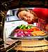 woman roasting vegetables in oven